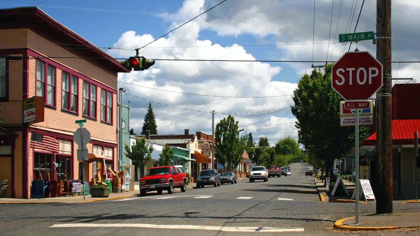 Downtown Ridgefield, Washington, looking along South Main Street past painted storefronts under a blue sky.