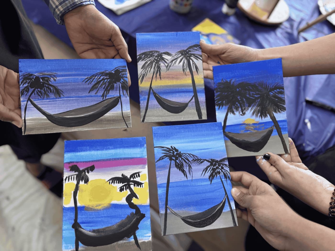 Beach-scene canvases from an Uplift paint night