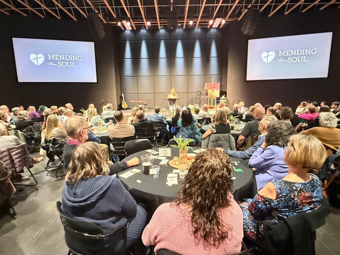 Hundreds of guests seated at an organizational wellness event Uplift ran